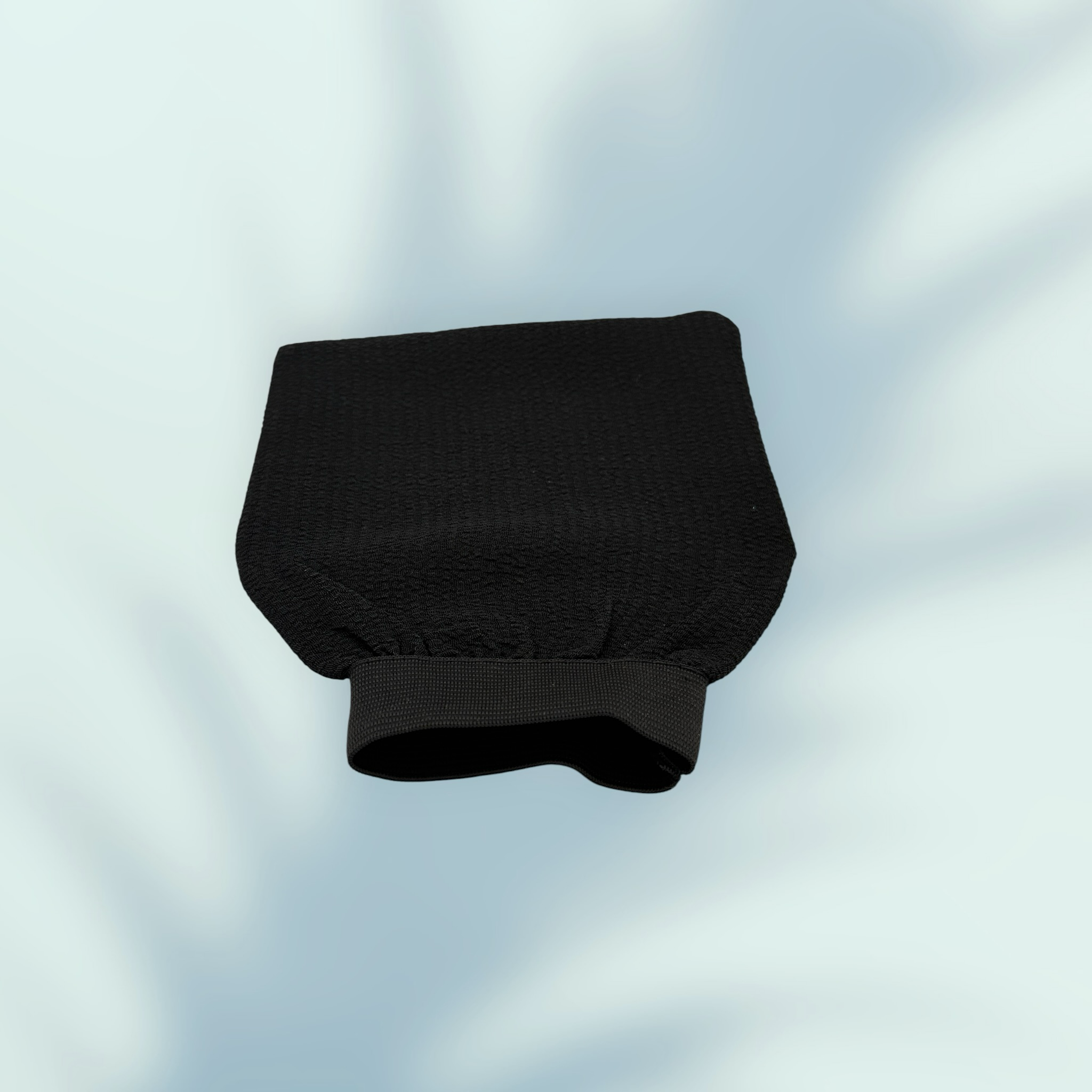Bellanisa black exfoliating glove made from natural fiber for deep skin cleansing and rejuvenation.