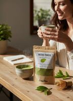 Bellanisa 100% Natural Premium Grade Matcha Powder beverage in a ceramic cup, with a pouch of matcha powder and a whisk on a wooden table.